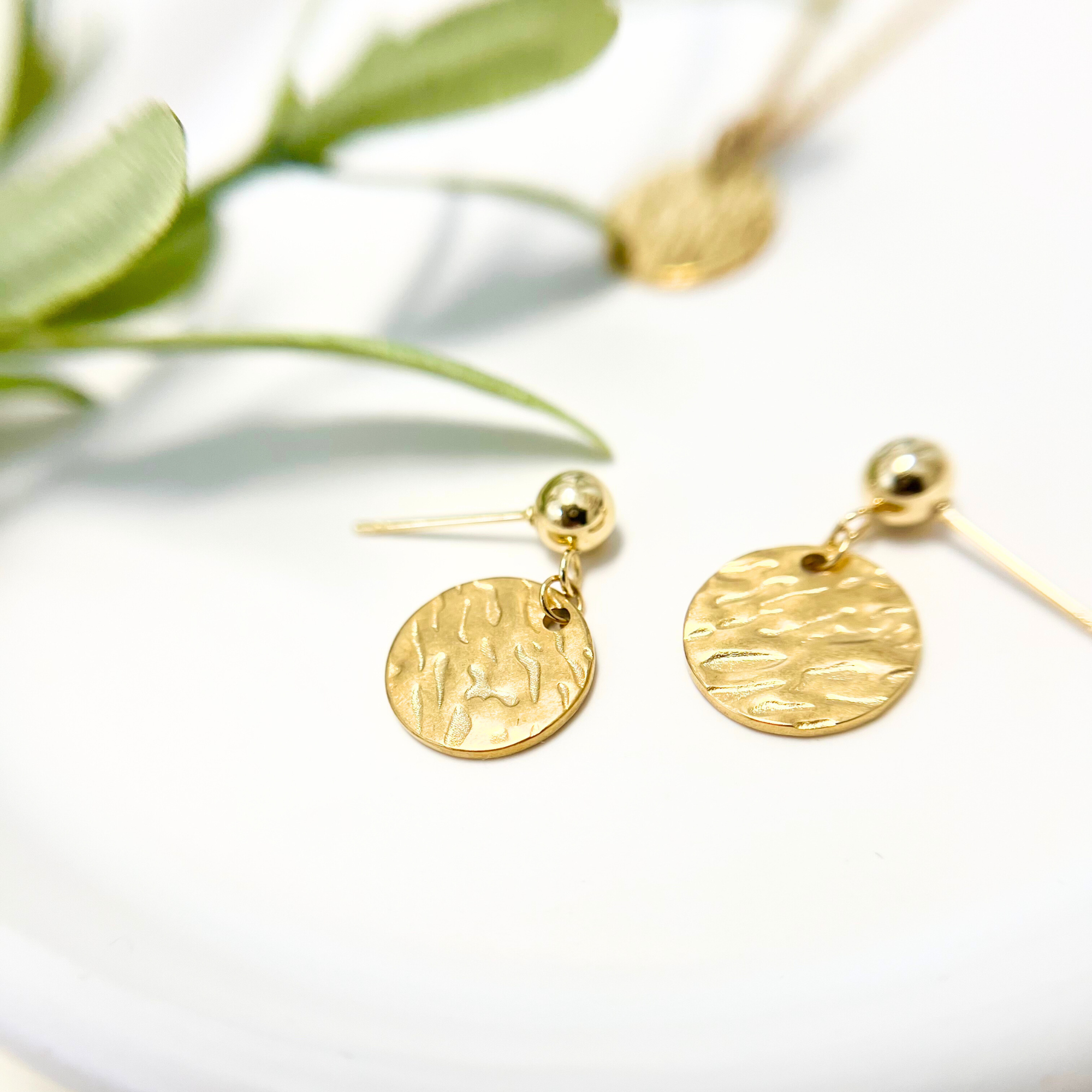 Handgemachte goldfarbene Edelstahl-Ohrstecker ORO mit gehämmertem Design und runder Struktur, glänzend und edel