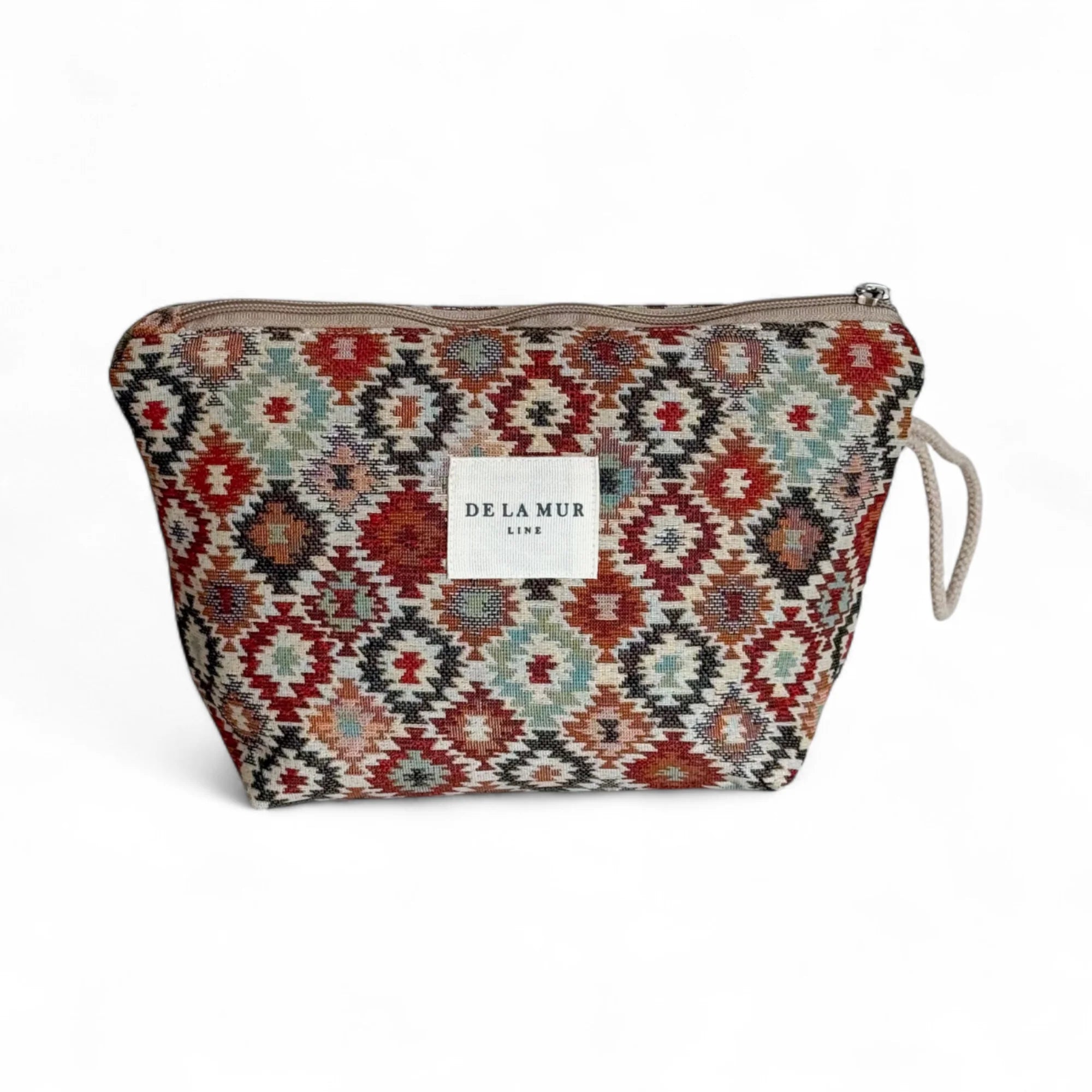Offene Kosmetiktasche aus gewebtem Jacquard-Stoff mit farbenfrohem Muster in Rost, Olivgrün und Hellblau. Die große Tasche dient zur Aufbewahrung von Make-up, Pflege oder Schmuck und ist von oben mit Reißverschluss zu öffnen.